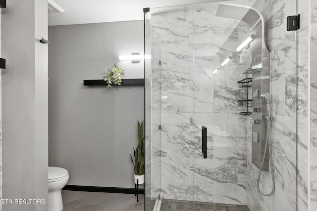 bathroom with an enclosed shower and toilet