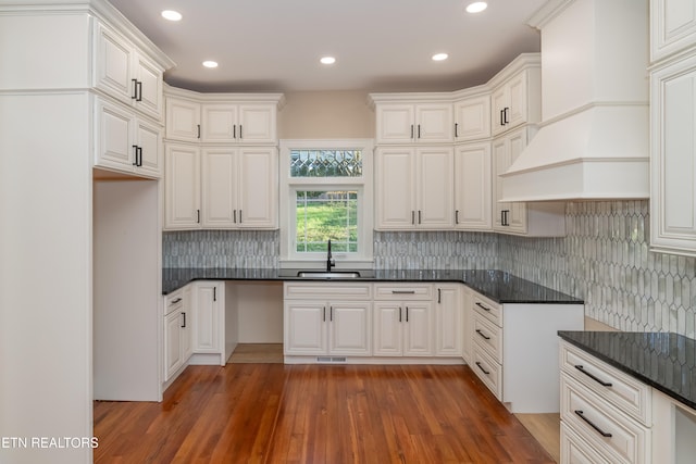 kitchen featuring white cabinetry, sink, dark hardwood / wood-style flooring, and premium range hood