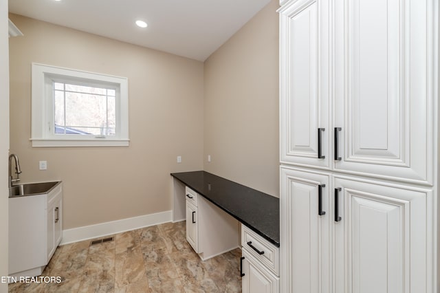 home office with built in desk and sink