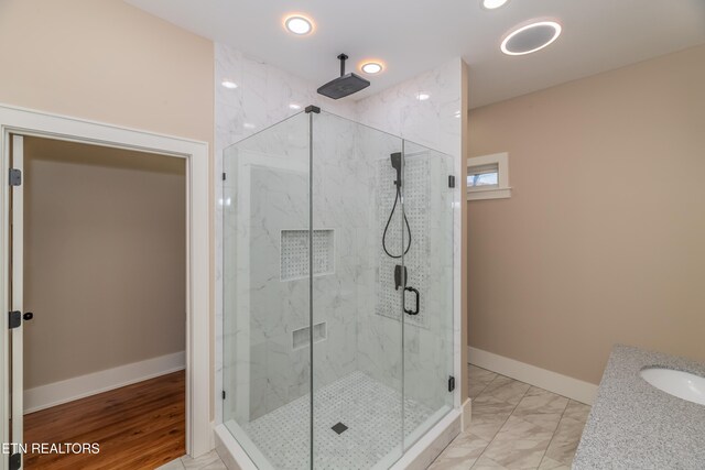 bathroom featuring sink and an enclosed shower