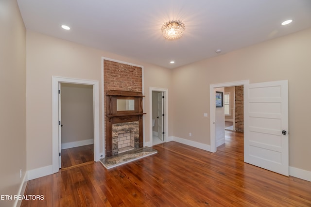 unfurnished living room with a premium fireplace and wood-type flooring