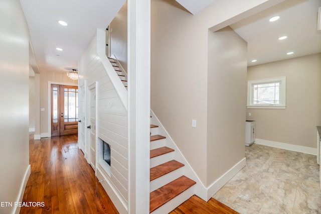 stairs with hardwood / wood-style floors