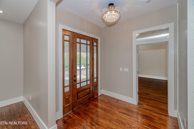 foyer featuring an inviting chandelier and hardwood / wood-style floors