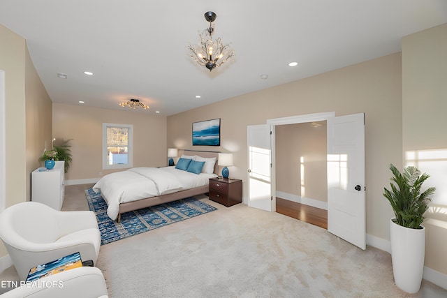 carpeted bedroom featuring a chandelier