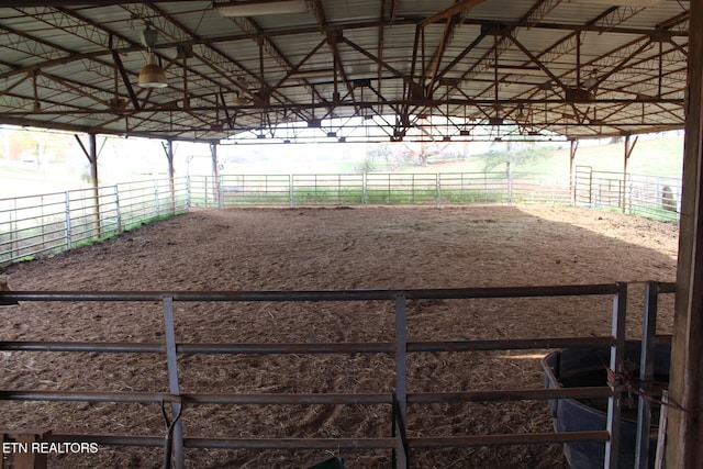 view of horse barn featuring a rural view