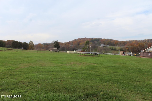 view of yard with a trampoline and a rural view