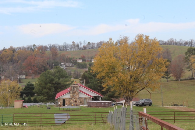 view of community featuring a yard and a rural view