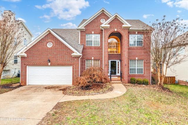 view of property with a garage and a front yard