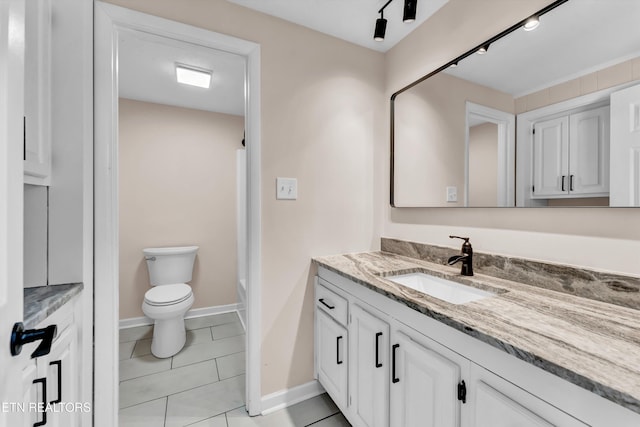 bathroom featuring tile patterned floors, vanity, and toilet