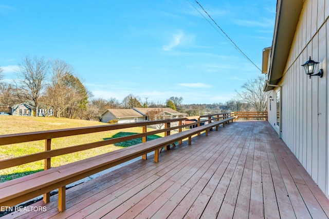 wooden deck with a lawn