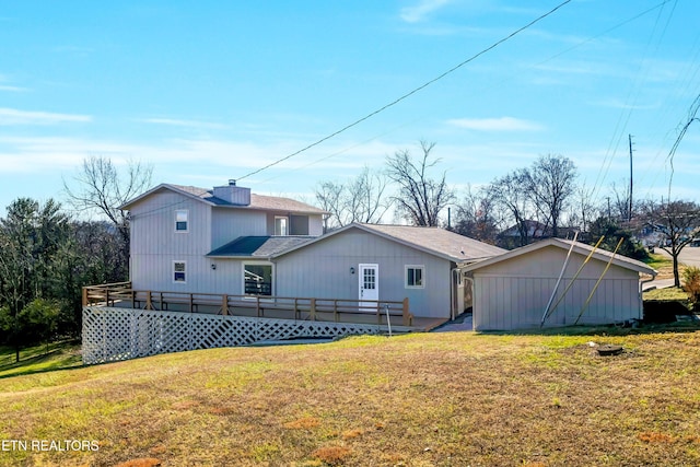 rear view of house with a yard and a deck