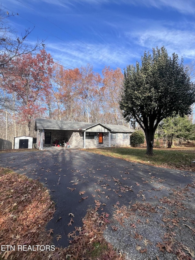 single story home featuring an outdoor structure and a garage