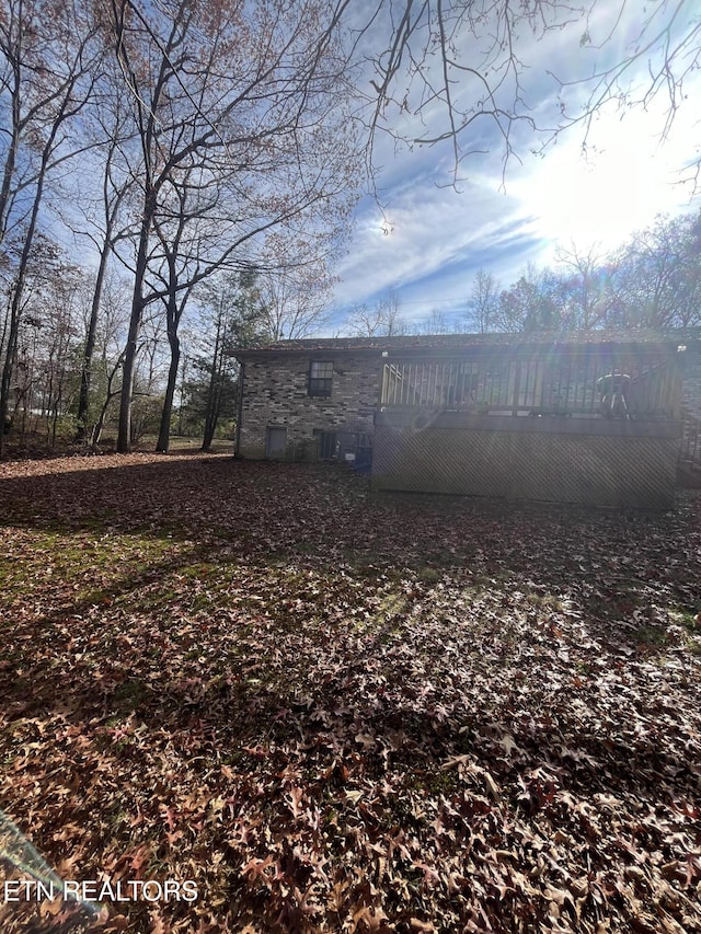 view of yard with a wooden deck