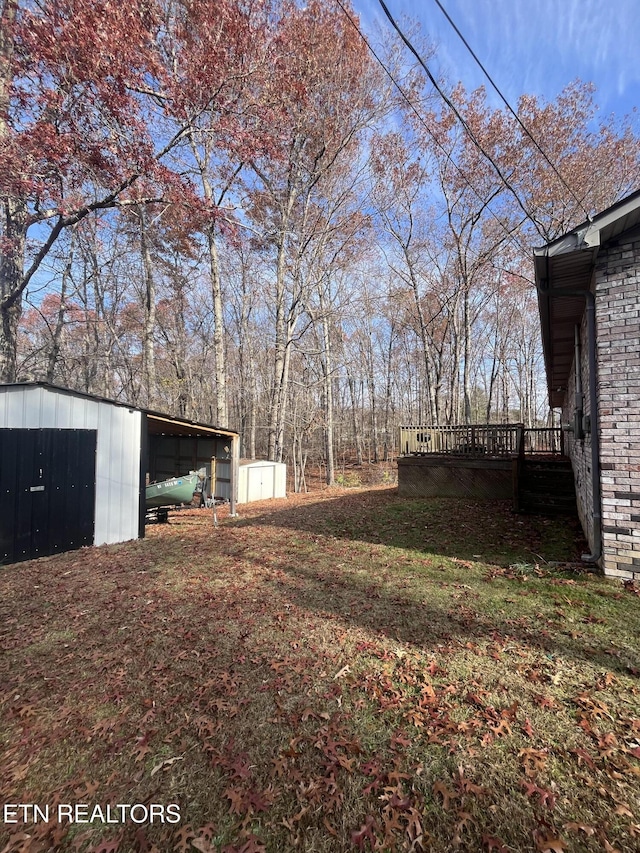 view of yard featuring a shed and a deck