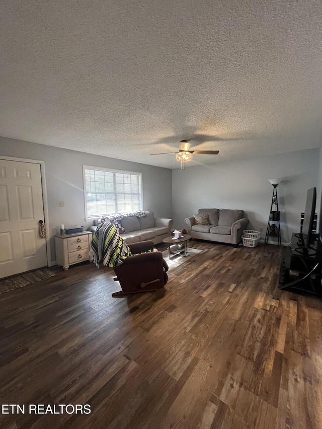 unfurnished living room featuring a textured ceiling, ceiling fan, and dark hardwood / wood-style floors