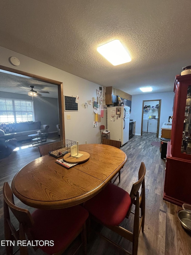 dining space featuring a textured ceiling, dark hardwood / wood-style flooring, washer / clothes dryer, and ceiling fan