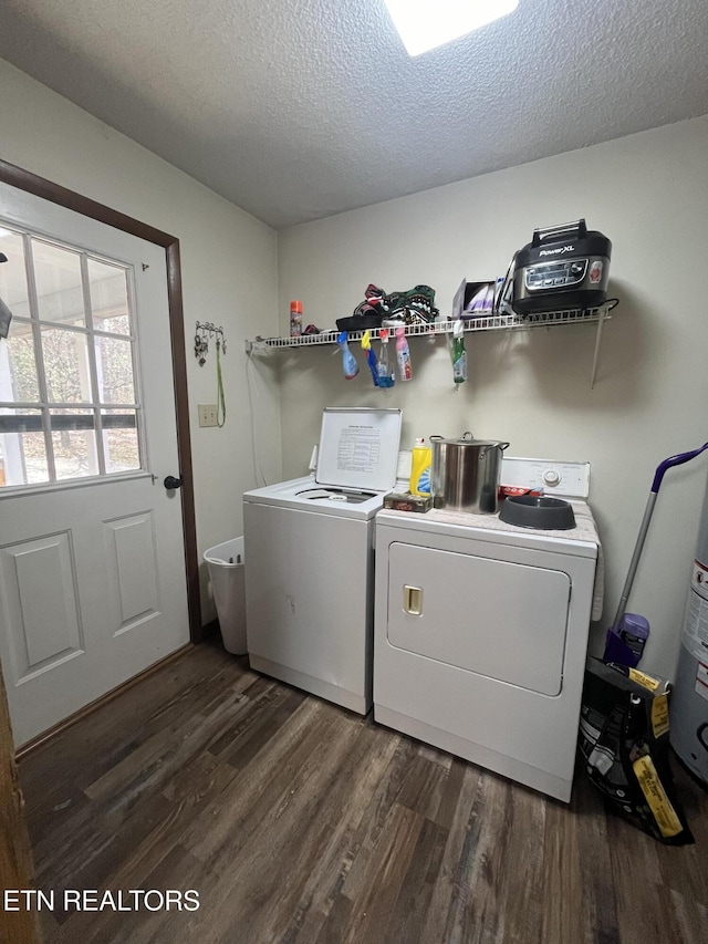 clothes washing area featuring separate washer and dryer, dark hardwood / wood-style flooring, and a textured ceiling