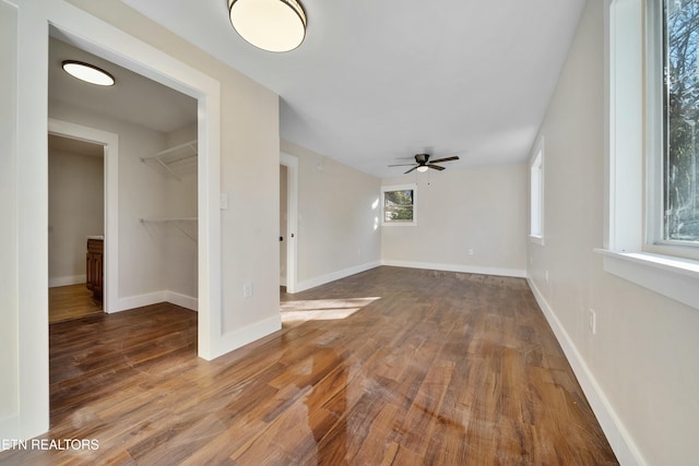 unfurnished living room featuring hardwood / wood-style flooring and ceiling fan