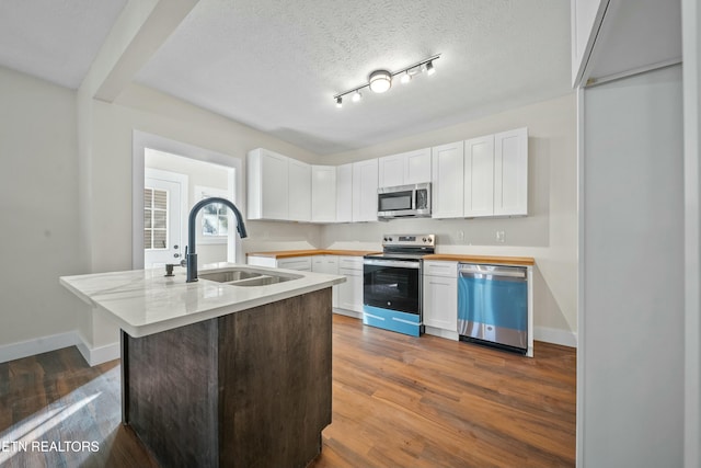 kitchen featuring a textured ceiling, sink, white cabinetry, and stainless steel appliances