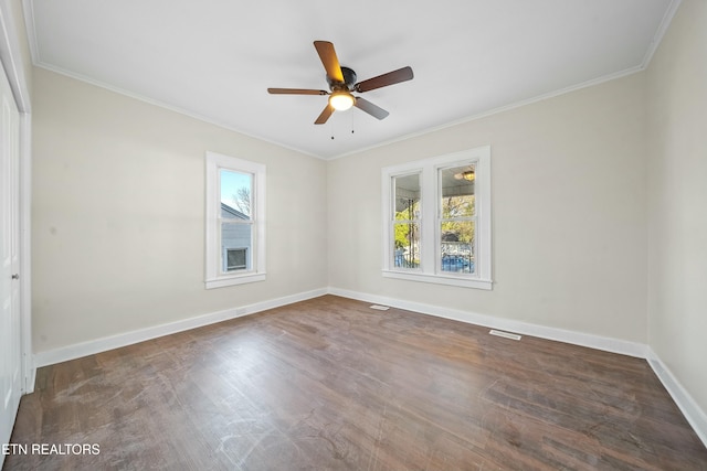 spare room featuring ceiling fan, crown molding, and dark wood-type flooring