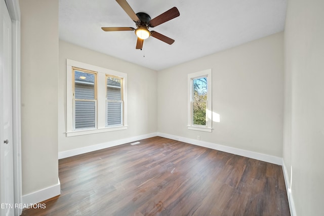 spare room featuring ceiling fan and dark hardwood / wood-style flooring