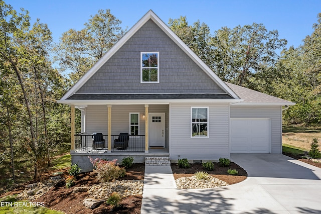 view of front of house featuring a porch and a garage