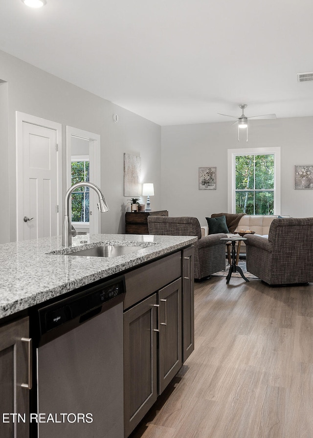 kitchen with dishwasher, light hardwood / wood-style floors, sink, and a wealth of natural light