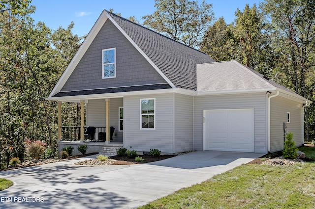 view of front facade with covered porch and a garage