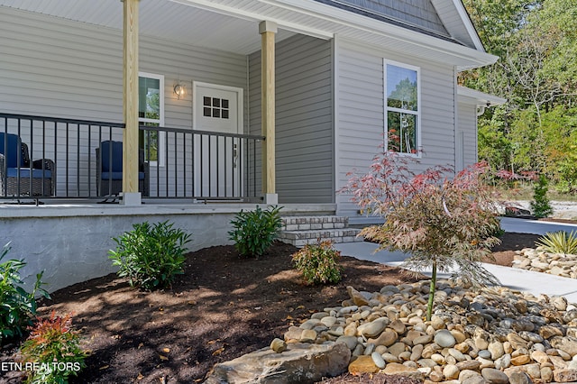 view of exterior entry with a porch