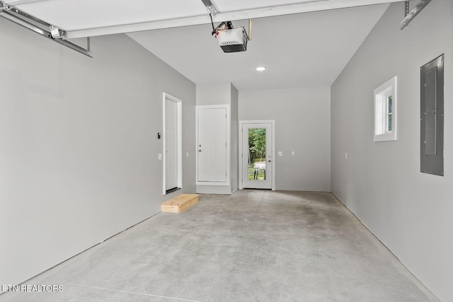 garage with electric panel and a garage door opener