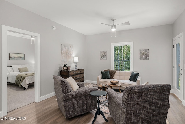 living room featuring light hardwood / wood-style flooring and ceiling fan