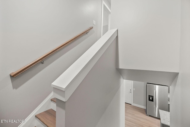 stairway with hardwood / wood-style floors