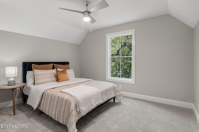 carpeted bedroom featuring vaulted ceiling and ceiling fan