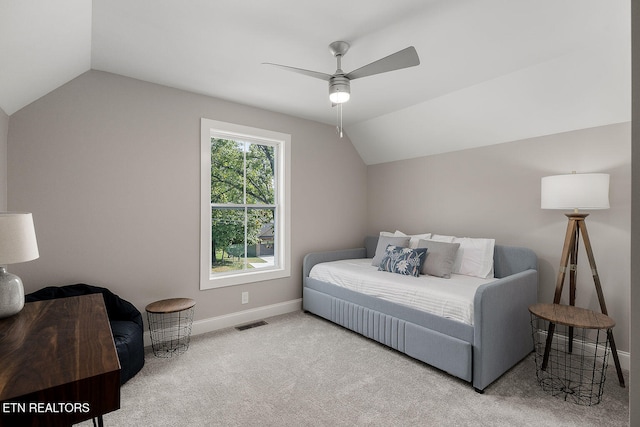 carpeted bedroom with ceiling fan and vaulted ceiling