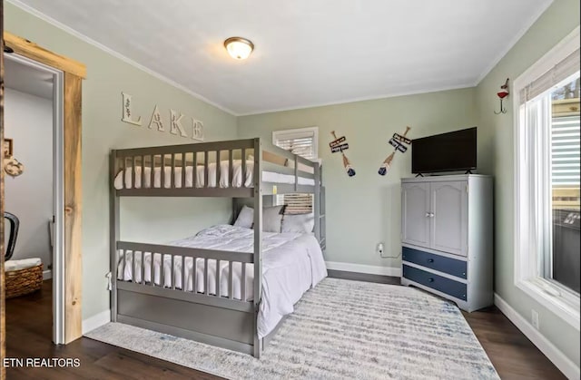 bedroom with ornamental molding and dark wood-type flooring