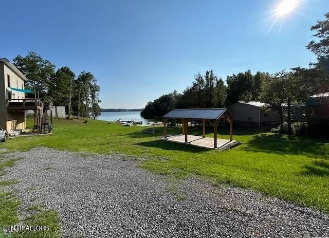 view of community featuring a gazebo, a yard, and a water view