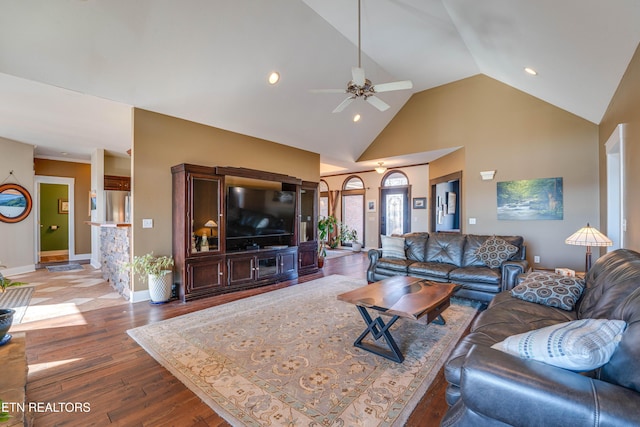 living room with ceiling fan, high vaulted ceiling, and hardwood / wood-style flooring