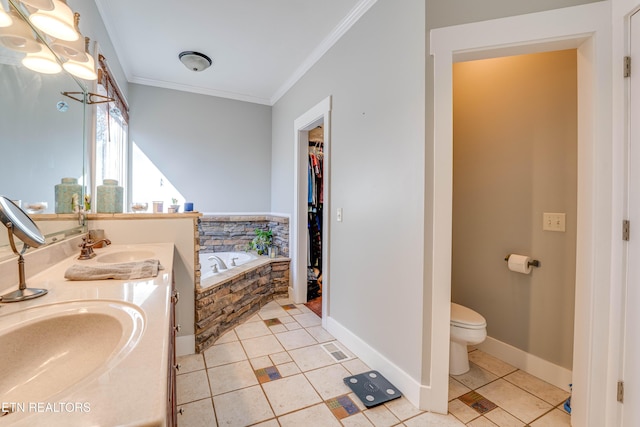 bathroom featuring vanity, crown molding, tile patterned flooring, toilet, and tiled tub