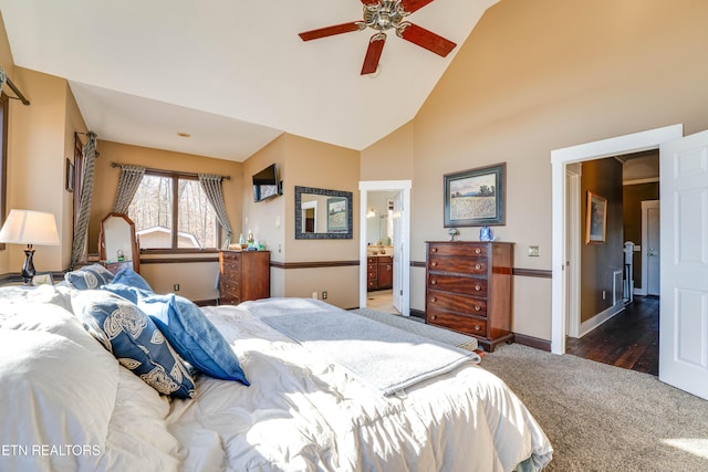 bedroom with dark hardwood / wood-style flooring, connected bathroom, high vaulted ceiling, and ceiling fan