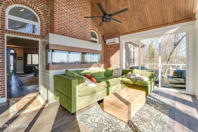 sunroom featuring a wall unit AC, ceiling fan, wooden ceiling, and vaulted ceiling