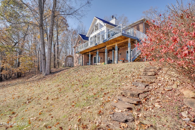 exterior space with a wooden deck and a storage unit