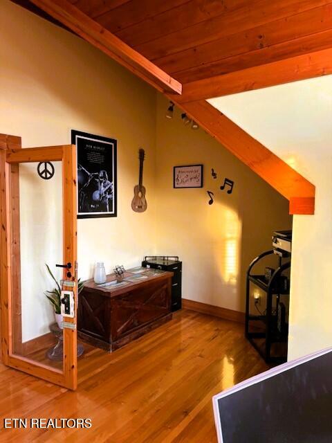 interior space featuring hardwood / wood-style flooring and wooden ceiling