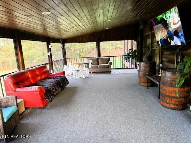 sunroom / solarium featuring vaulted ceiling and wooden ceiling