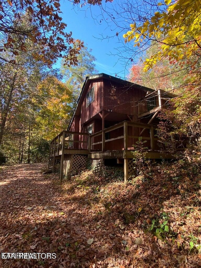 view of side of home with a wooden deck