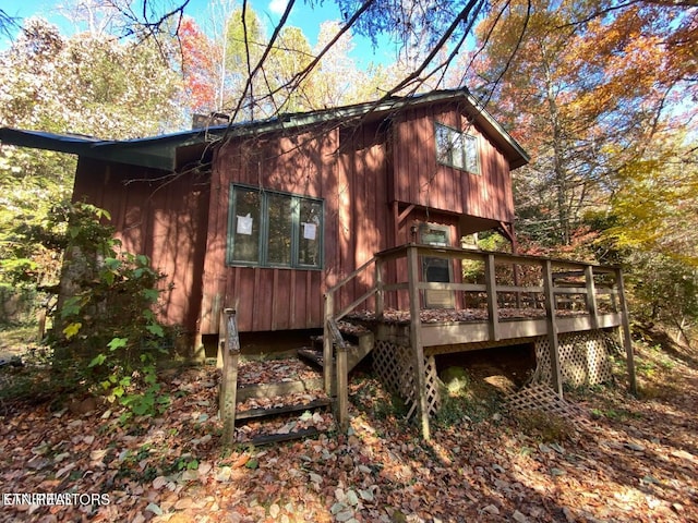 back of property featuring a wooden deck