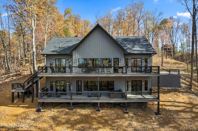 back of house with a wooden deck and french doors