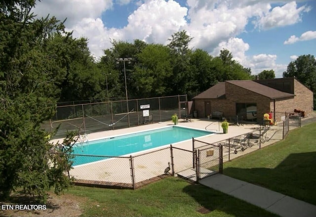 view of swimming pool with a patio area and a yard