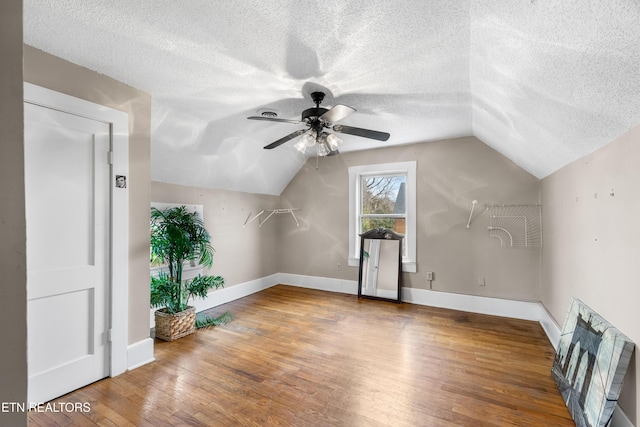 bonus room featuring lofted ceiling, wood finished floors, and baseboards