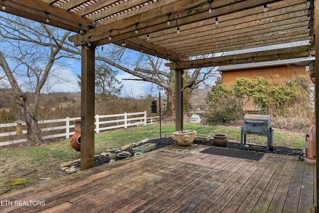 deck with a fenced backyard and a pergola