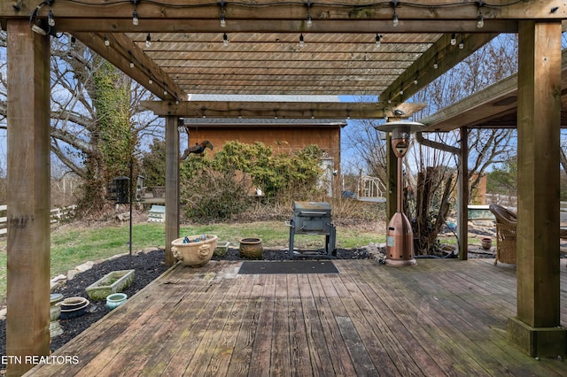 wooden terrace with a grill and a pergola